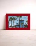Blue Baby – colourful fine art photography by Noëlle Nijhuis for NOË NÍ, a large-scale luxury framed wall art piece featuring a blue Mediterranean house and palm trees