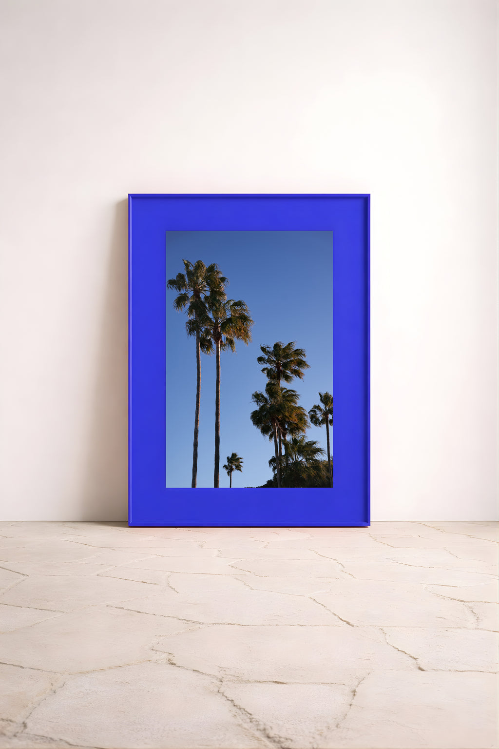 Large-scale wall art ‘Paseo Palms’ by Noëlle Nijhuis for NOË NÍ, bright and calming fine art photography of tropical palms moving in the breeze. Shop yours now